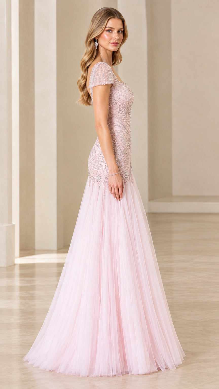 Side view of woman wearing blush pink cap sleeve beaded formal tulle gown
