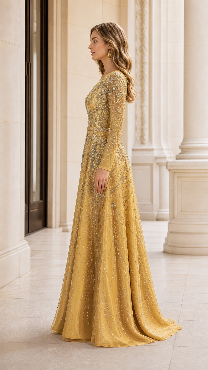 Side profile view of gold long sleeve embellished floor-length formal dress