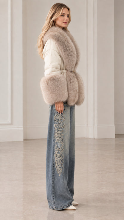 Side profile of woman modeling cream belted winter jacket with plush fur collar and cuffs