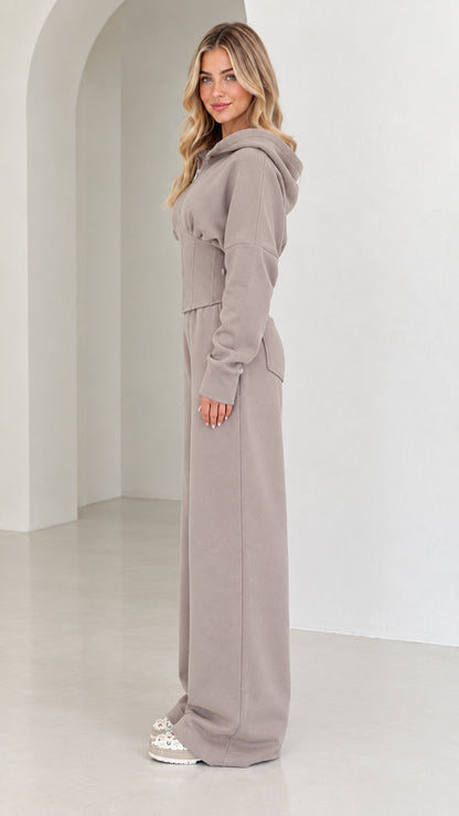 Side profile view of taupe corset tracksuit set showcasing tailored silhouette