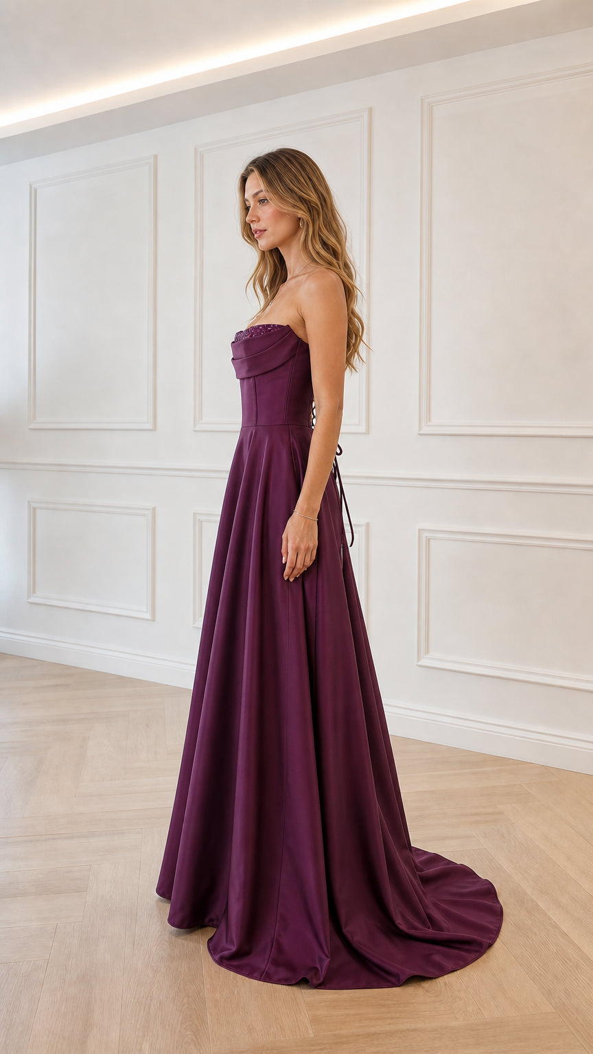 Side view of model in plum satin formal gown