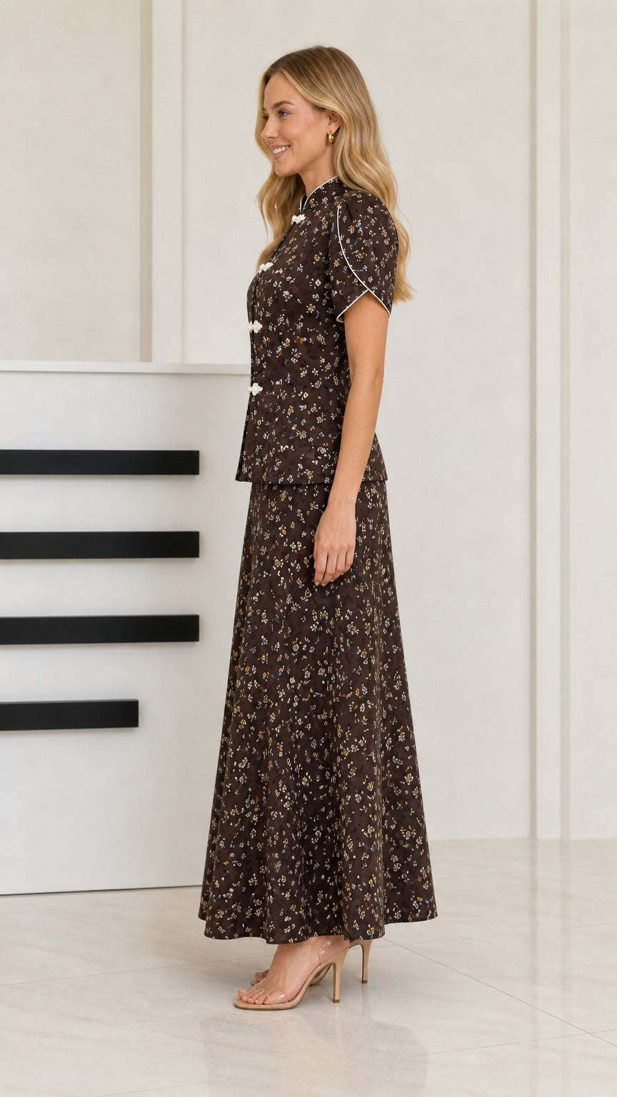 Side view of woman wearing dark brown floral two-piece maxi set