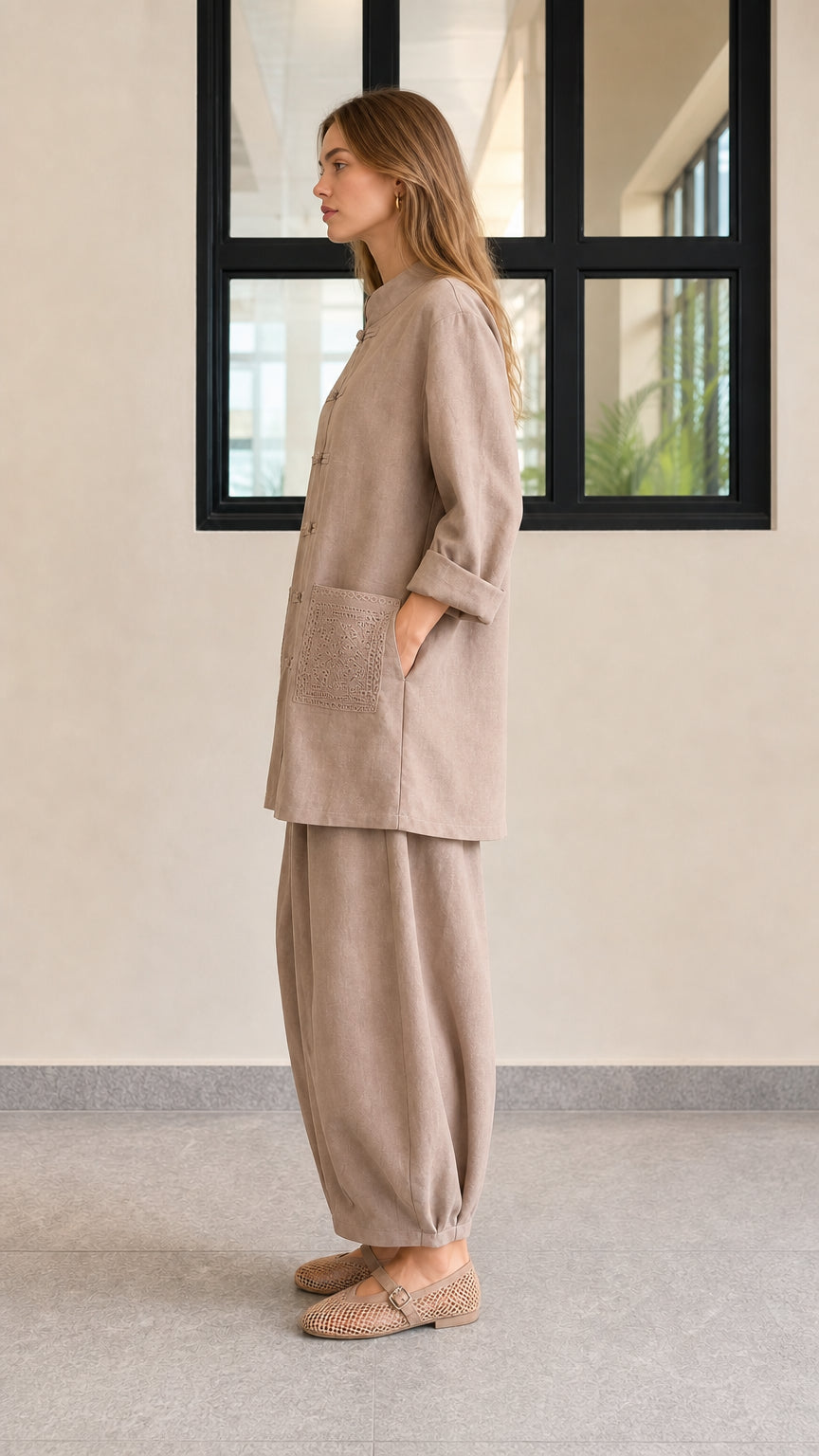 Side profile view of taupe casual two-piece tunic and lantern pants set