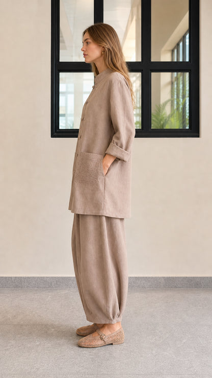 Side profile view of taupe casual two-piece tunic and lantern pants set