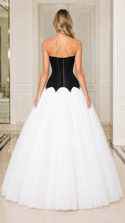 Back view of model in black boned corset bodice and white tulle ball gown skirt