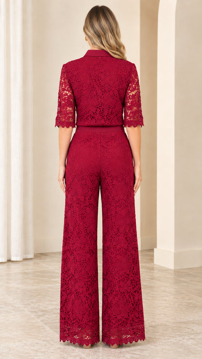 Back view of woman wearing elegant burgundy lace wide-leg collared jumpsuit