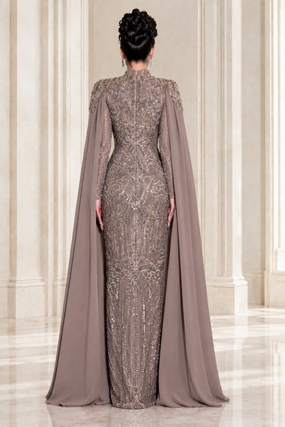 Back view of taupe high neck evening gown showing sweeping cape detail