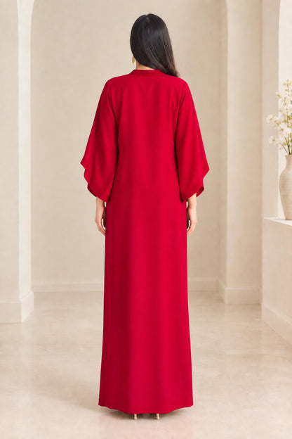 Back view of woman wearing floor-length red kaftan dress