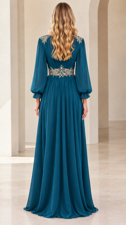 Back view of teal blue pleated chiffon evening gown showcasing beaded waistband and shoulder detail