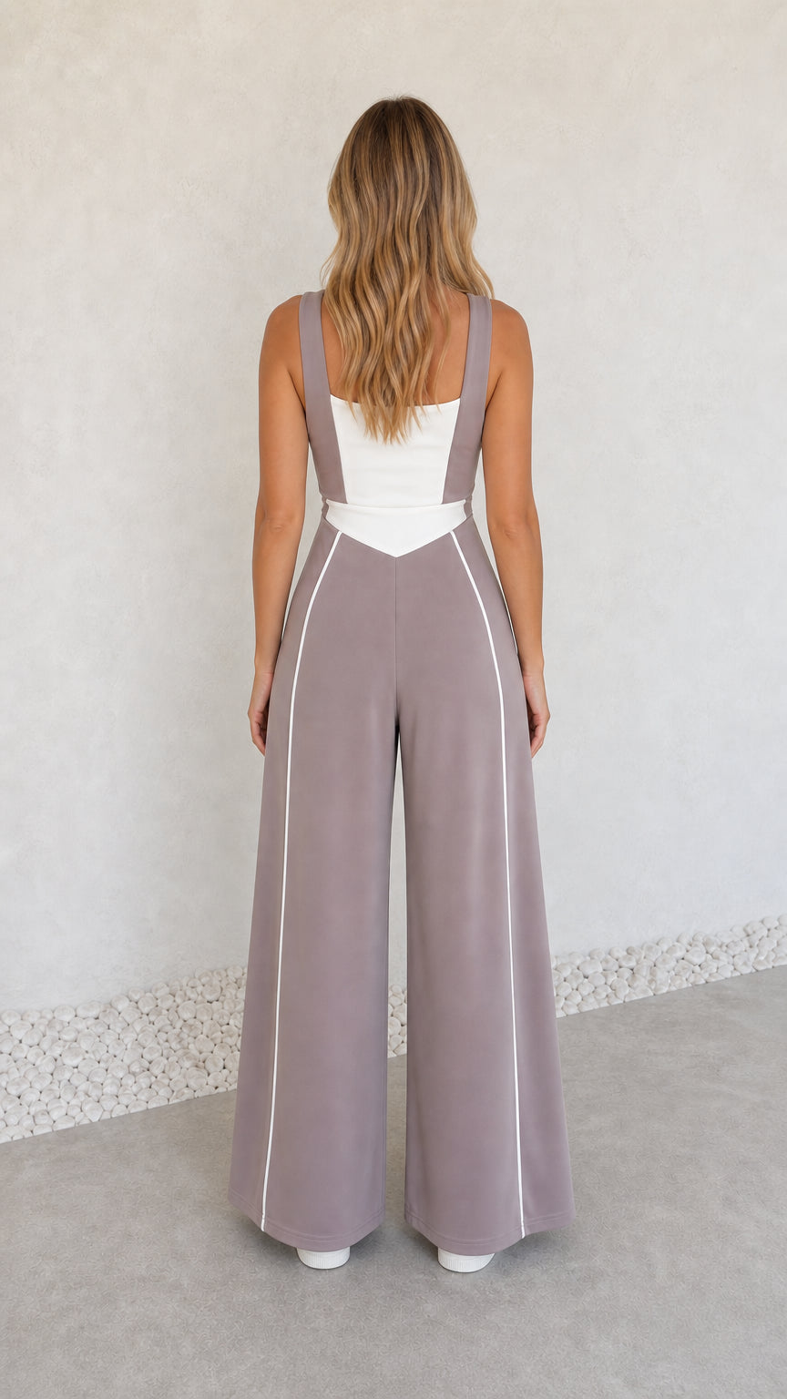 Back view of model wearing dusty mauve square neck wide-leg jumpsuit
