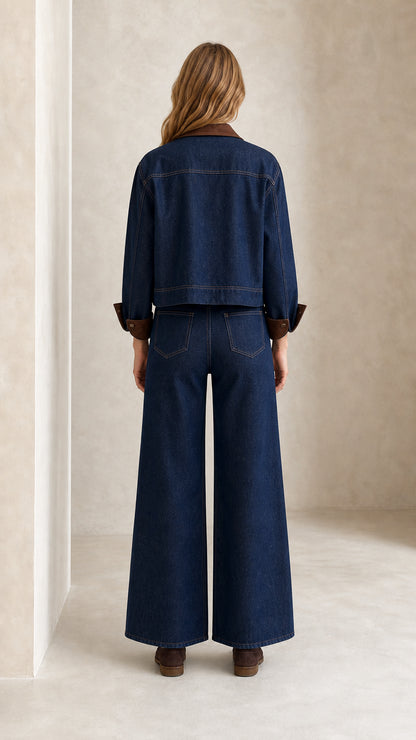 Back view of model wearing Indigo Blue denim jacket and high waist wide leg trousers