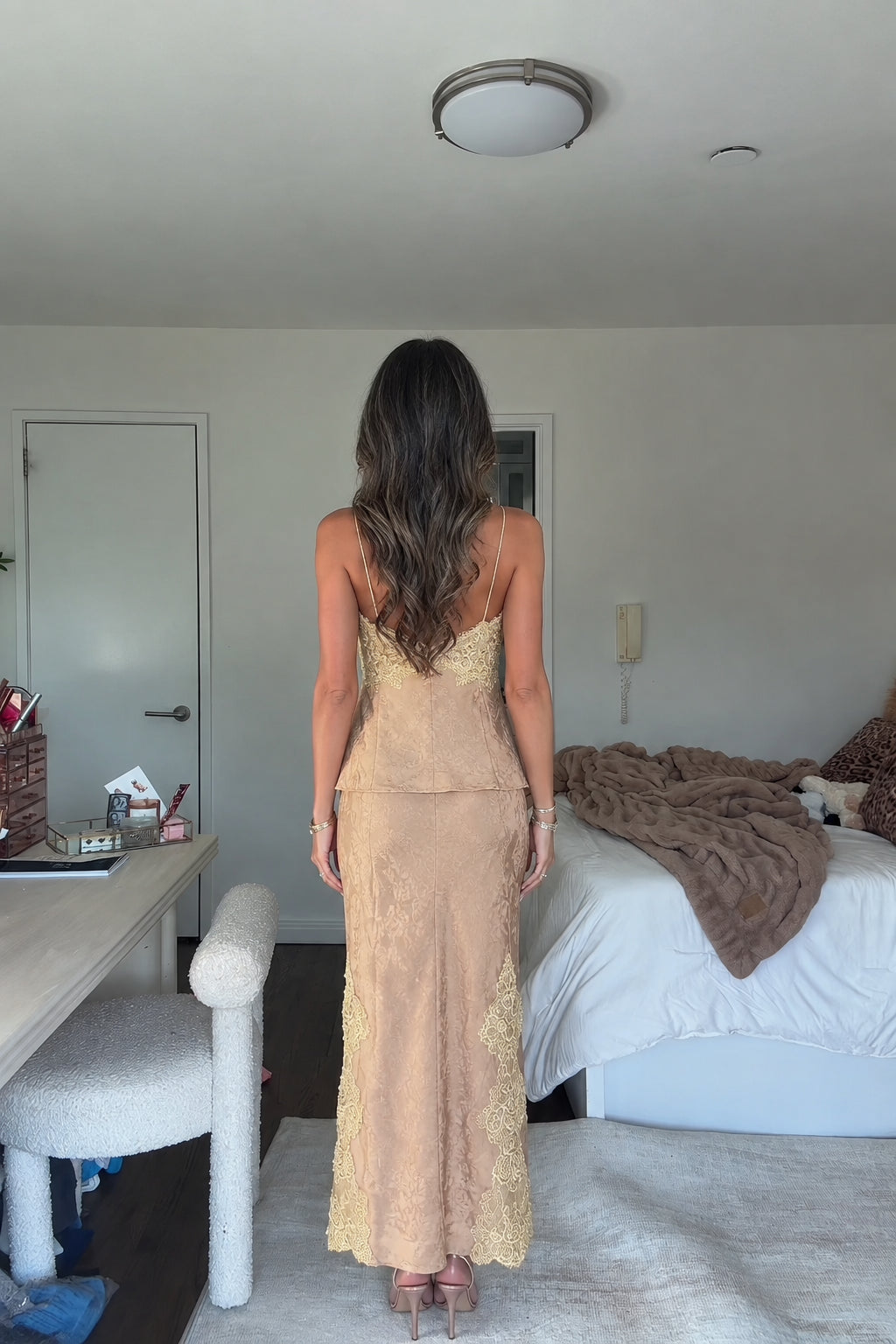 Back view of model in champagne gold jacquard two-piece midi skirt set