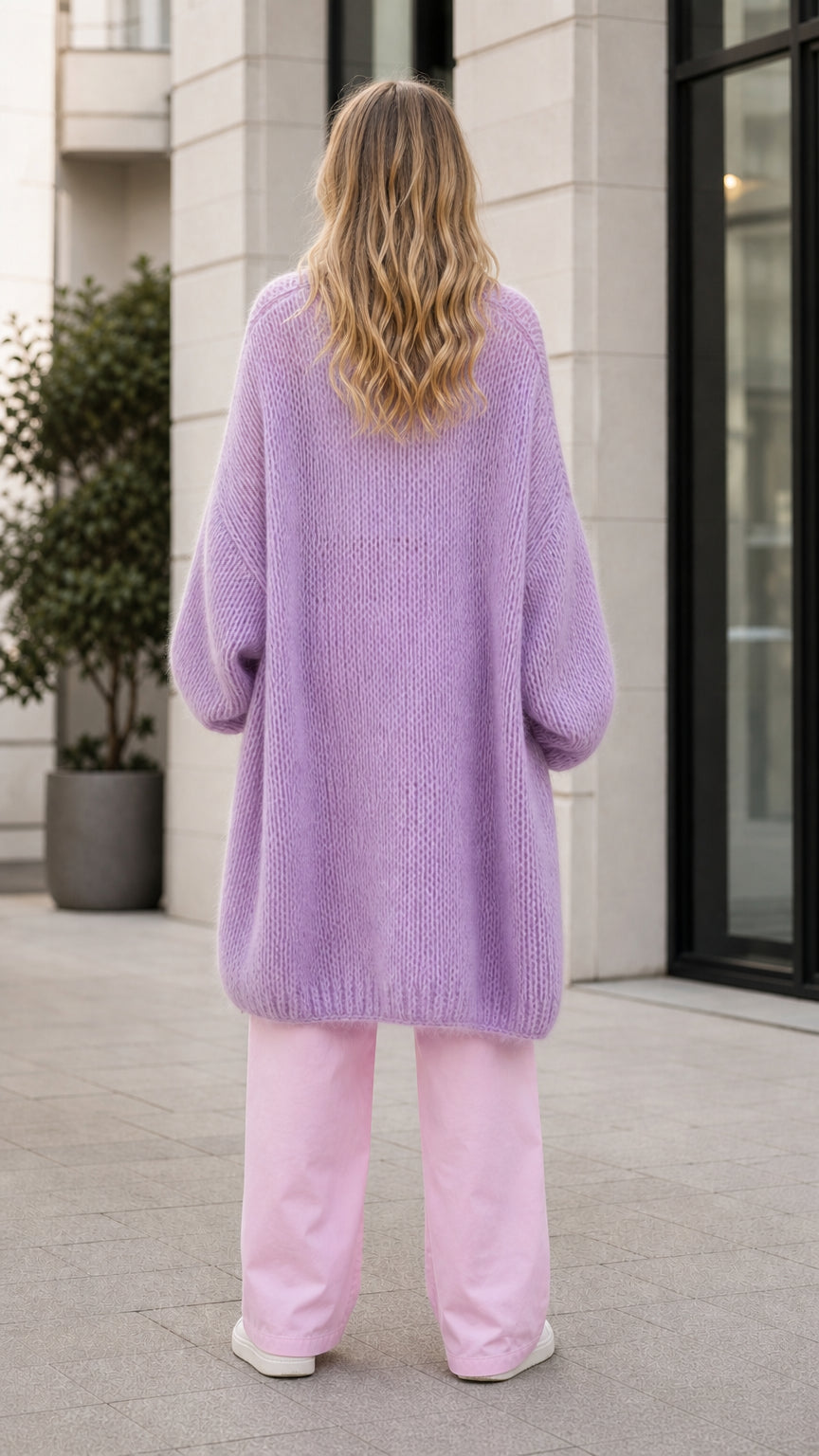 Model wearing lavender oversized knit cardigan back view