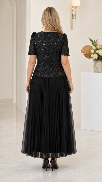 Back view of black sequin bodice and pleated formal maxi dress