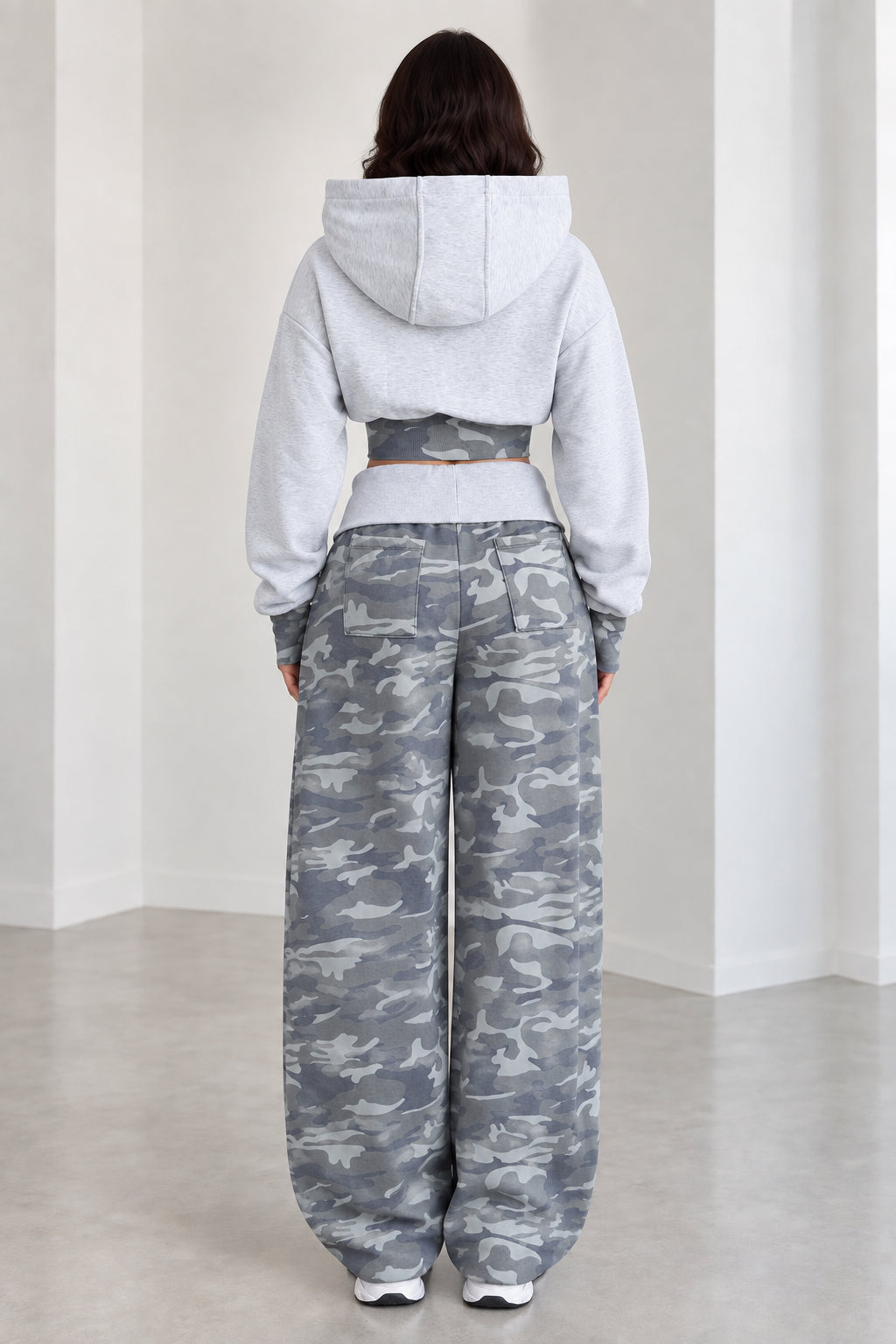 Back view of model wearing Heather Grey cropped hoodie and camo sweatpants set
