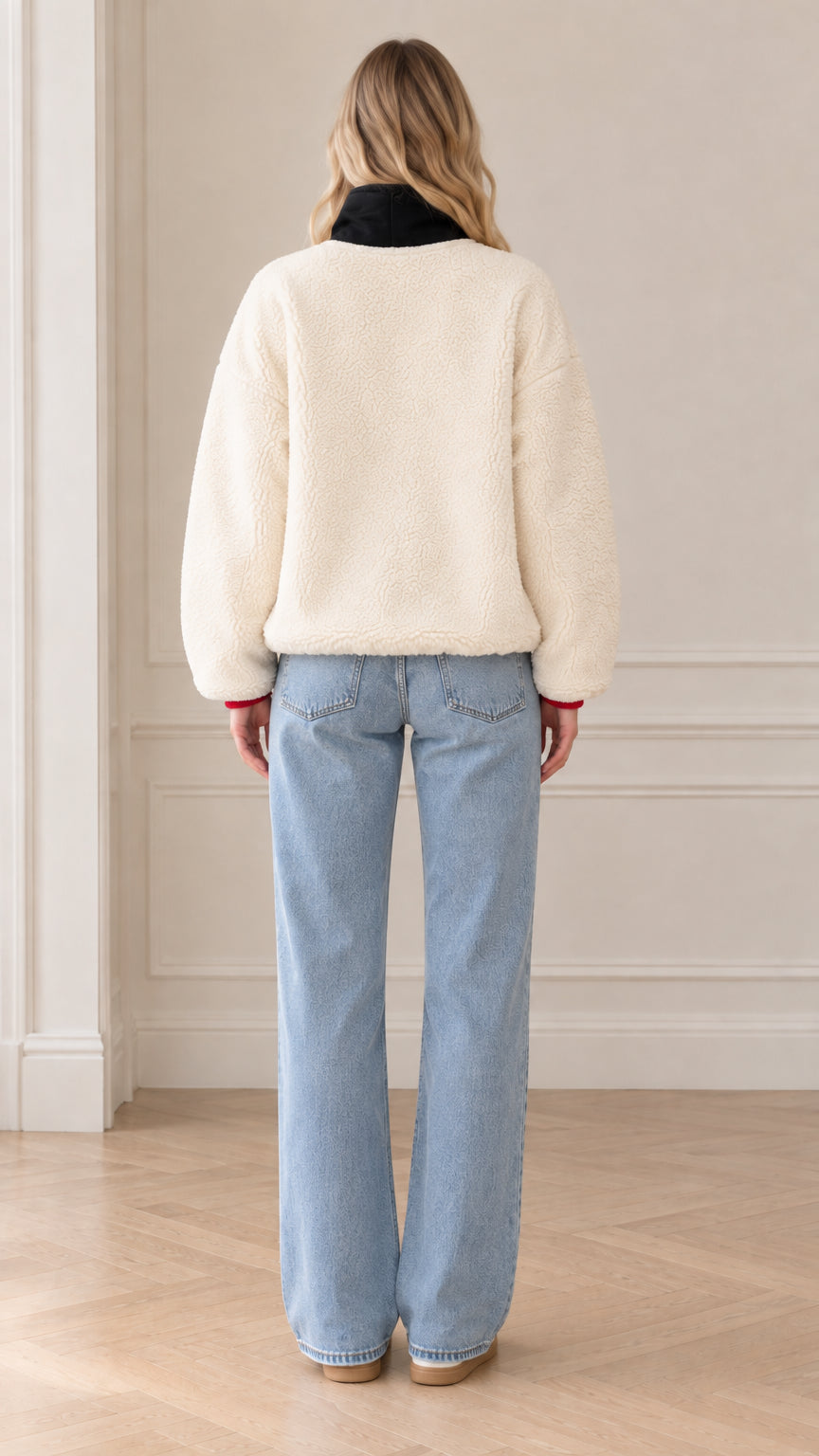 Back view of model wearing cream cozy fleece pullover with contrast collar