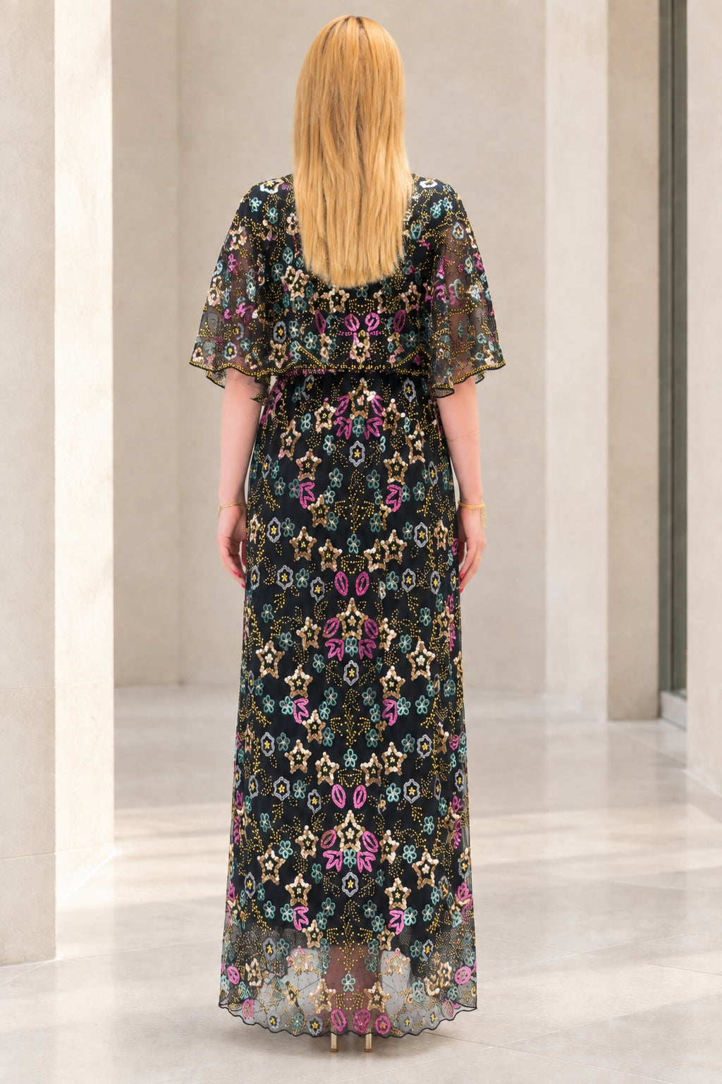 Back view of black floral sequin overlay maxi dress