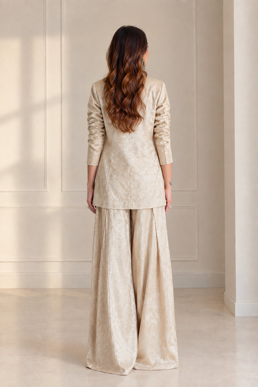 Back view of model wearing Champagne longline blazer and wide-leg trousers
