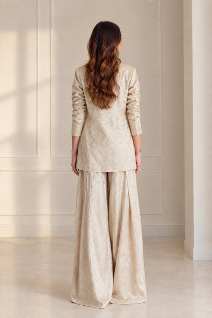 Back view of model wearing Champagne longline blazer and wide-leg trousers