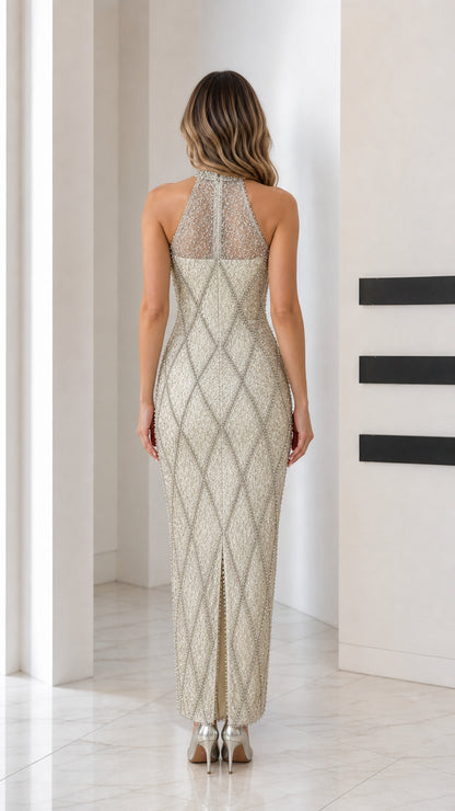 Back view of champagne halter maxi dress showing back slit and beadwork