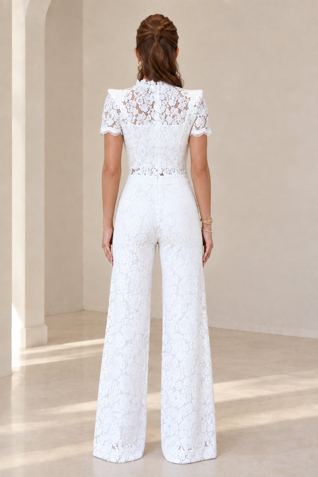 Back view of model wearing white lace top and wide leg trousers set