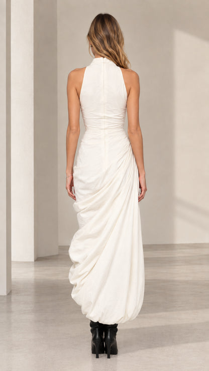 Back view of model wearing ivory high neck fitted bodice maxi dress
