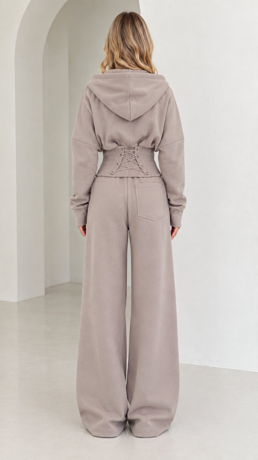 Back view of taupe set highlighting corset lace-up waist detail and wide-leg fit