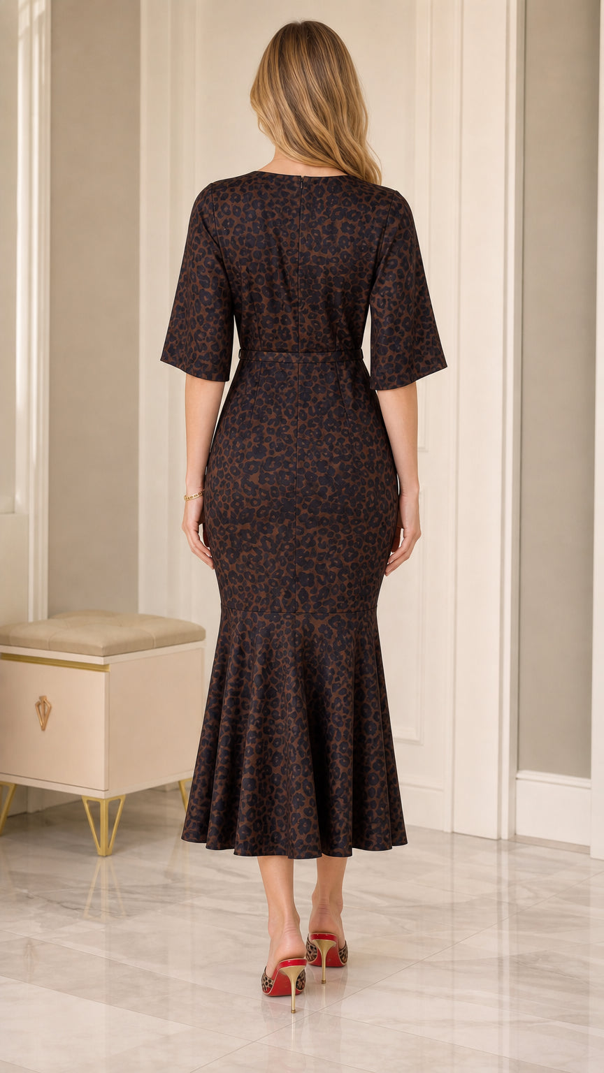 Back view of model wearing Dark Brown animal print midi dress with elbow flutter sleeves