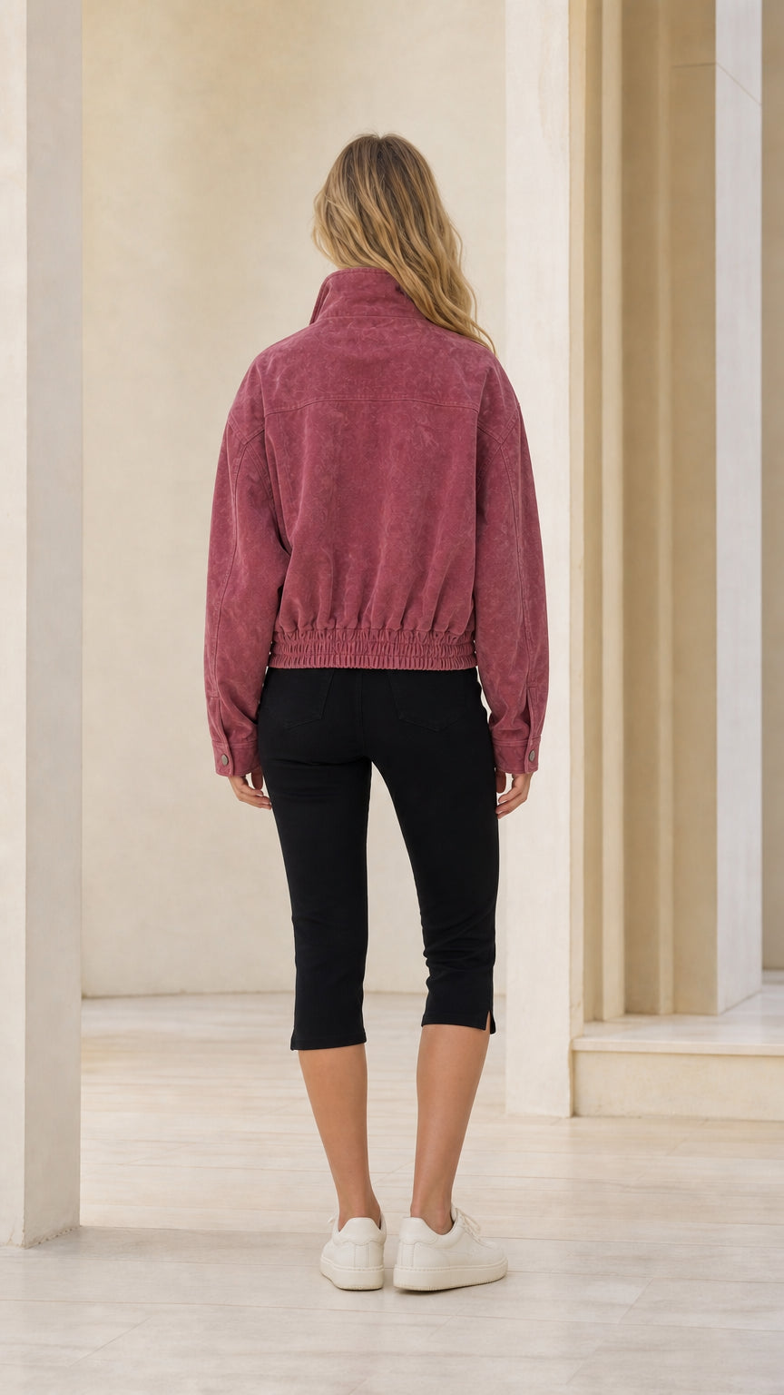 Back view of woman wearing rose pink bomber jacket
