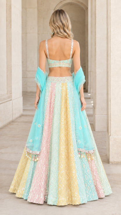 Back view of model in pastel multi panel lehenga with sweetheart choli back