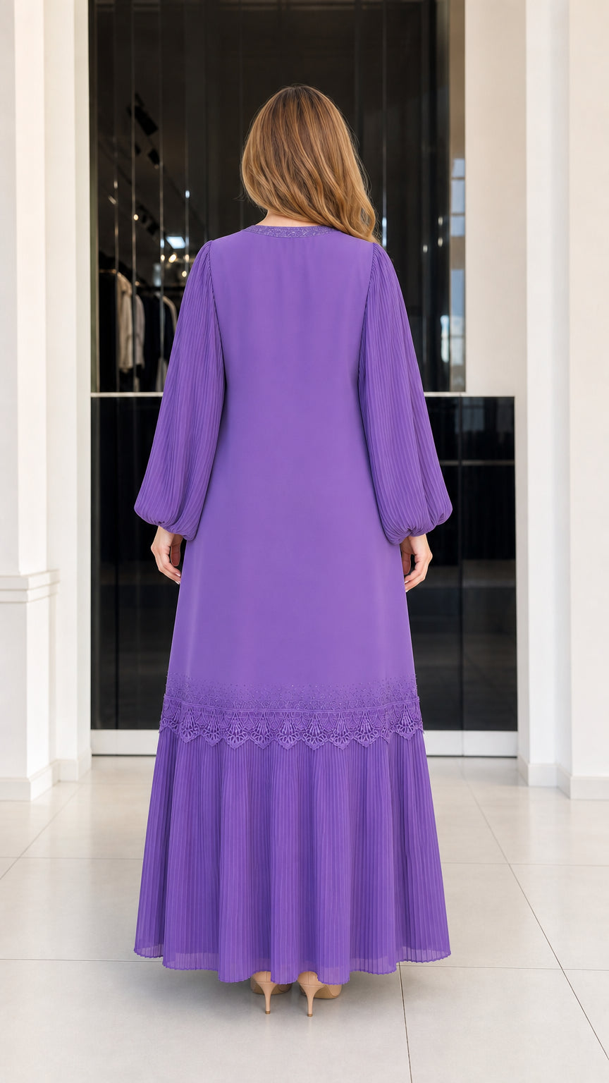 Back view of woman wearing purple flowing maxi dress with pleated hem tier