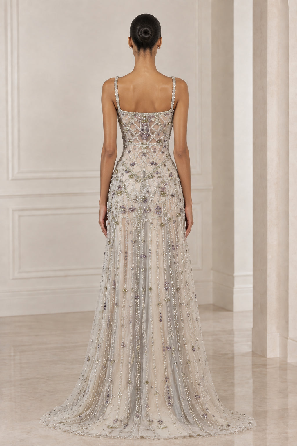 Back view of model showcasing square back and flowing train of Silver Champagne gown
