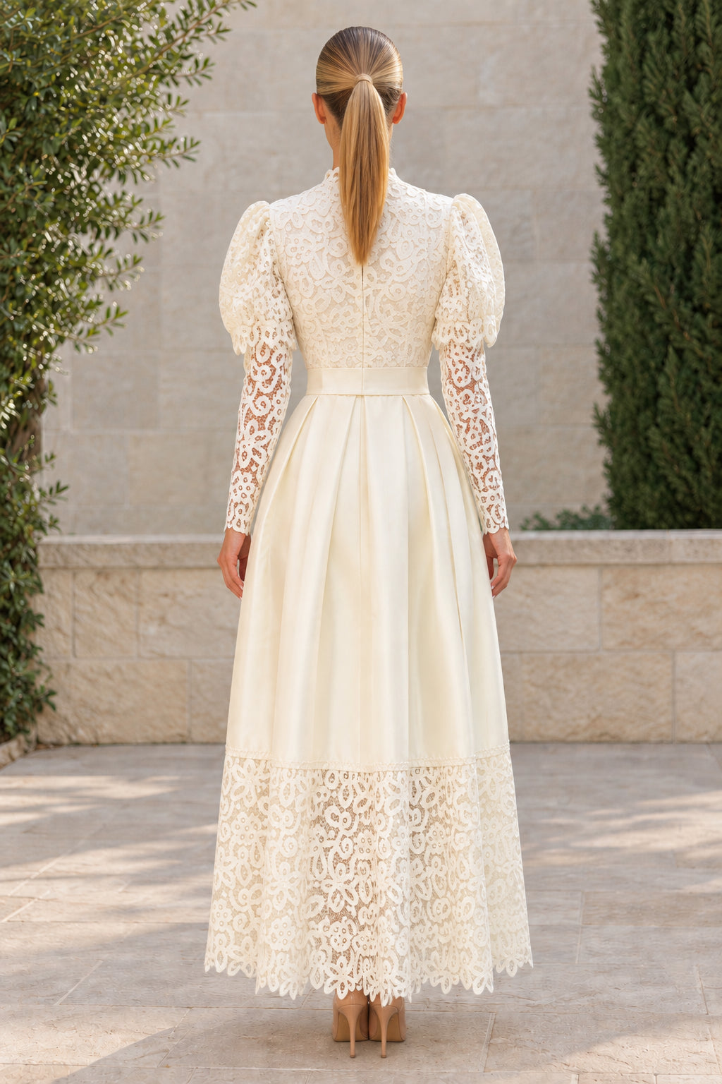Back view of ivory long sleeve lace and pleated satin A-line maxi dress