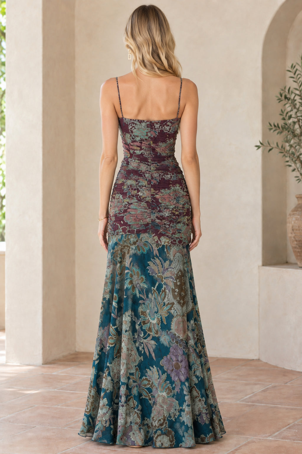 Back view of model wearing burgundy floral spaghetti strap floor-length dress