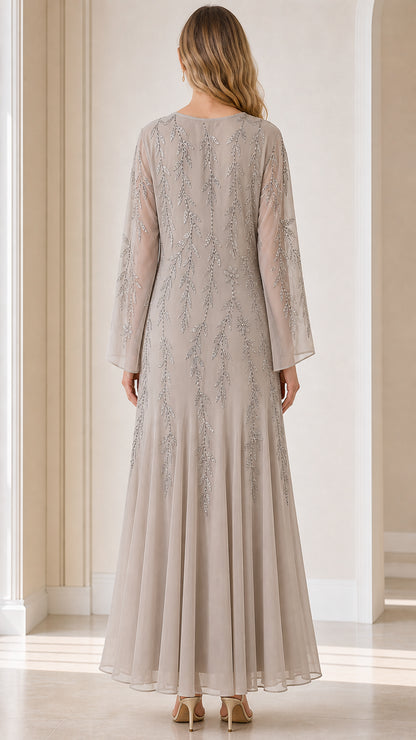 Back view of model showcasing flowing maxi skirt and long sleeves