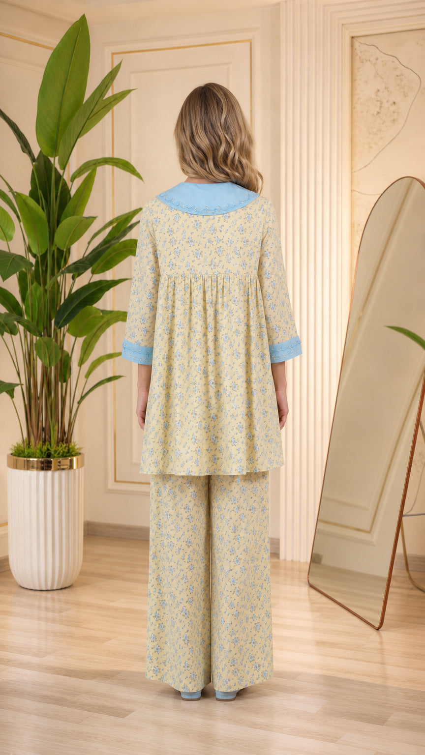 Back view of model in pastel yellow floral tunic pajama set