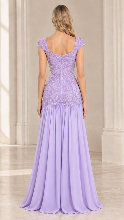 Back view of woman wearing lavender drop waist evening gown with cap sleeves