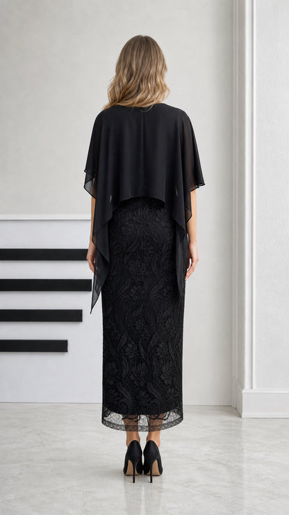 Back view of black midi dress showing chiffon capelet draping