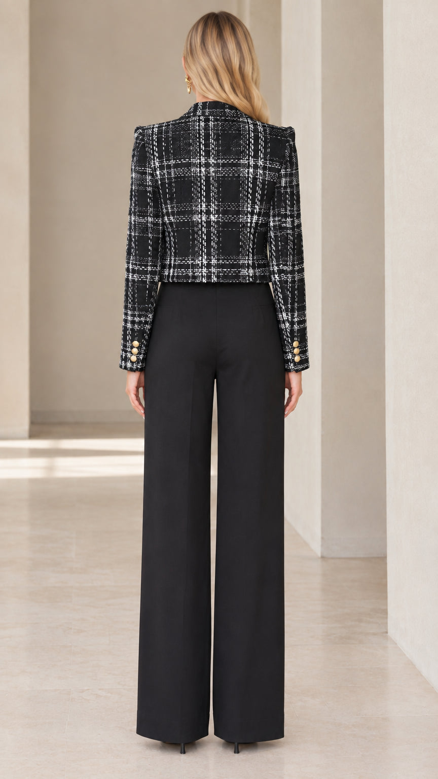 Back view of tailored black plaid cropped tweed jacket with structured shoulders