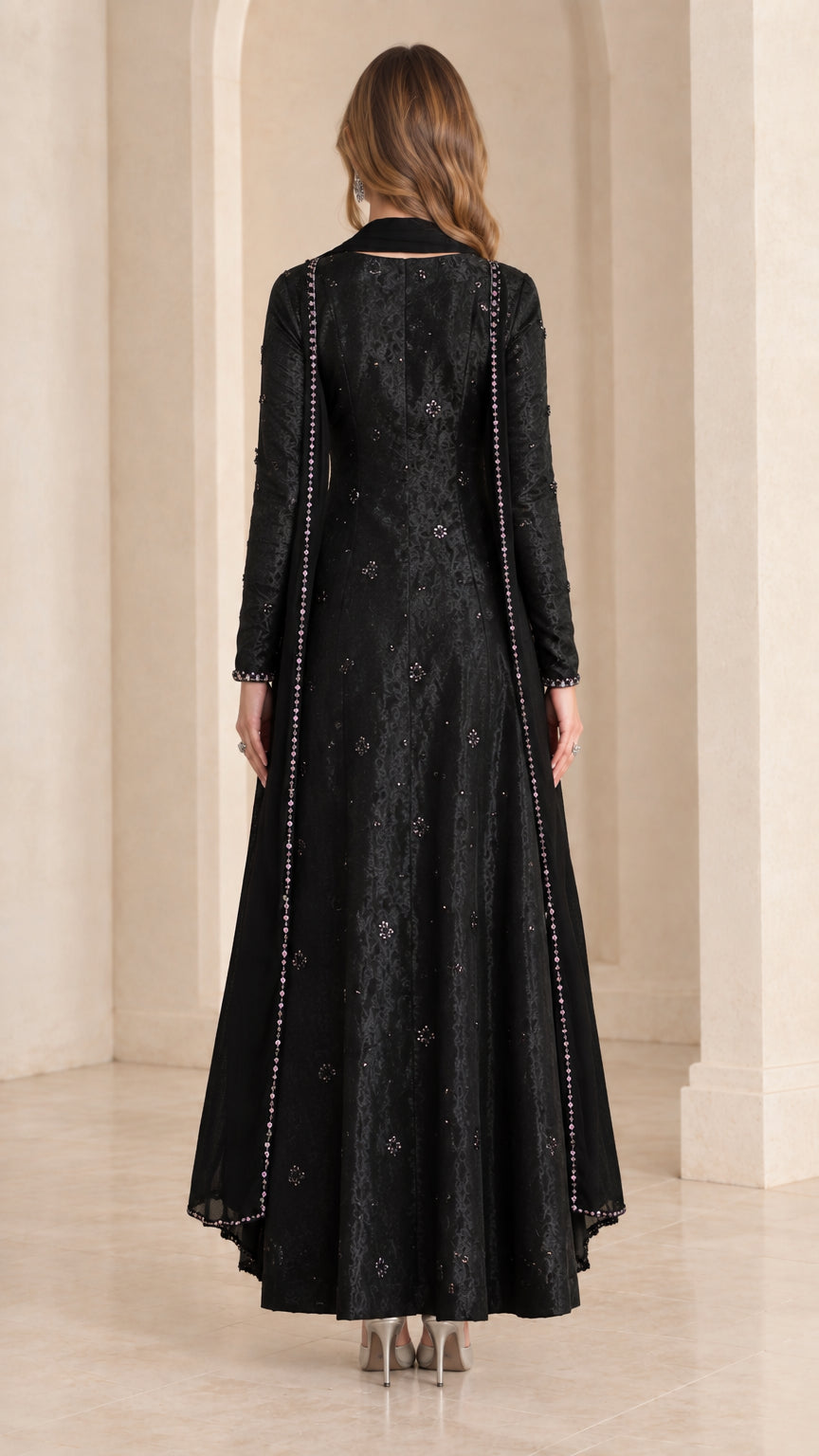 Back view of black long sleeve A-line maxi dress with matching scarf drape