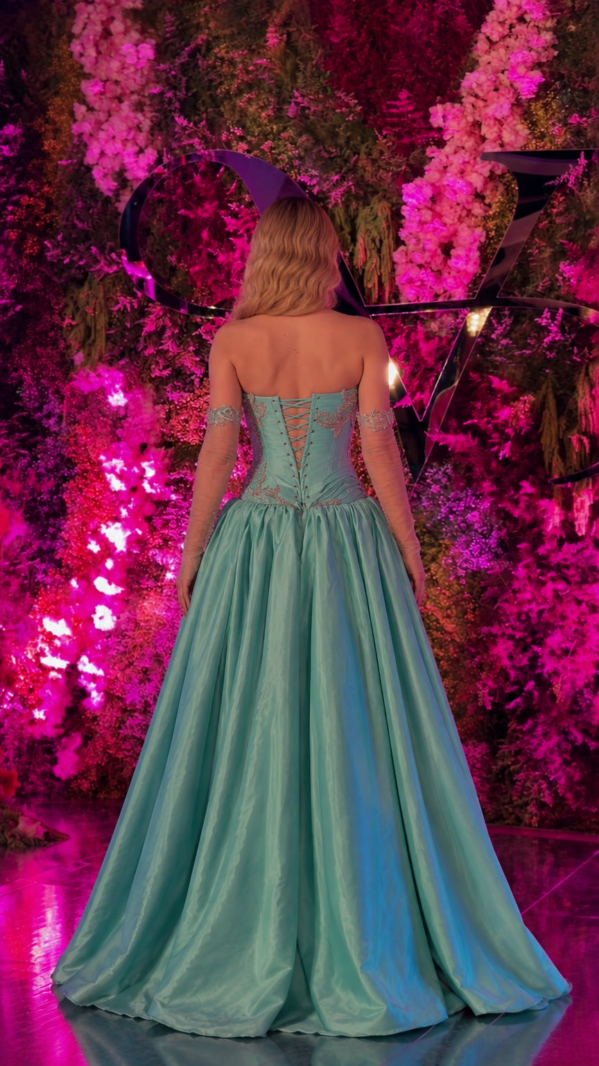 Back view of turquoise evening dress showing lace-up corset closure and flowing train