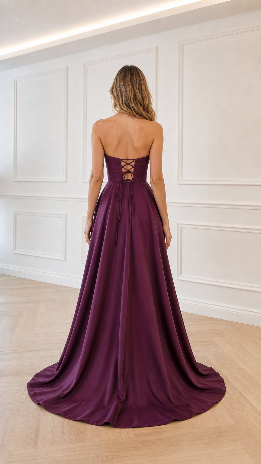 Back view of model showing lace-up corset detail on plum gown