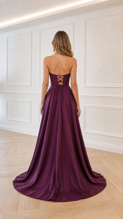 Back view of model showing lace-up corset detail on plum gown