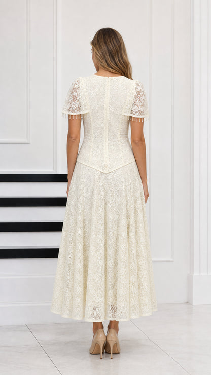 Back view of cream floral lace A-line maxi dress showing capelet back