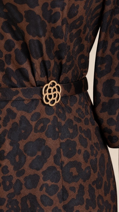 Close-up detail of the waistline and decorative buckle on the leopard print dress