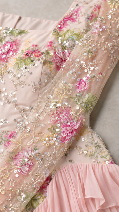 Close-up detail of intricate floral sequin embroidery and pleated chiffon ruffles