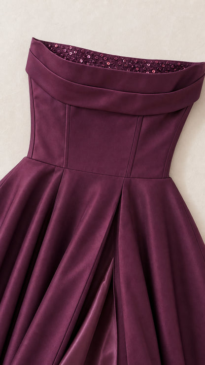 Close-up of structured strapless bodice with sequin trim on plum dress