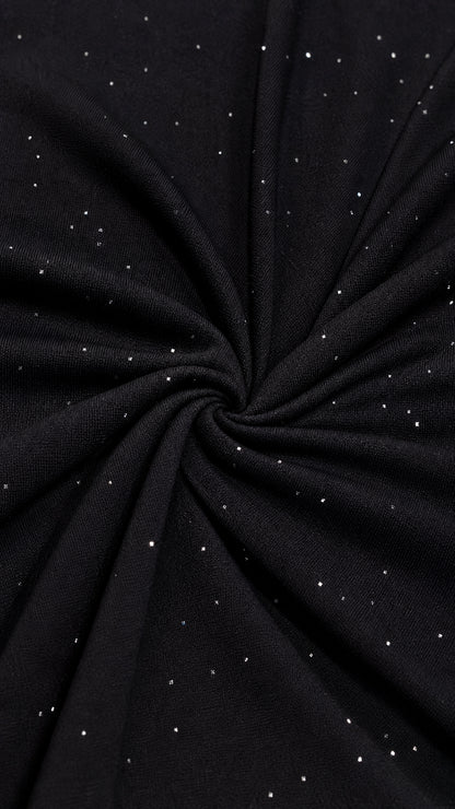 Close-up detail of black stretch fabric with delicate silver shimmer flecks