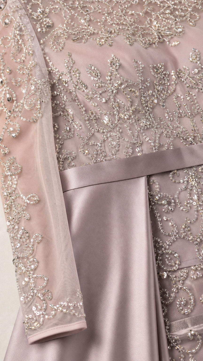 Close-up detail of silver beading, floral embroidery, and smooth satin waistband on gown