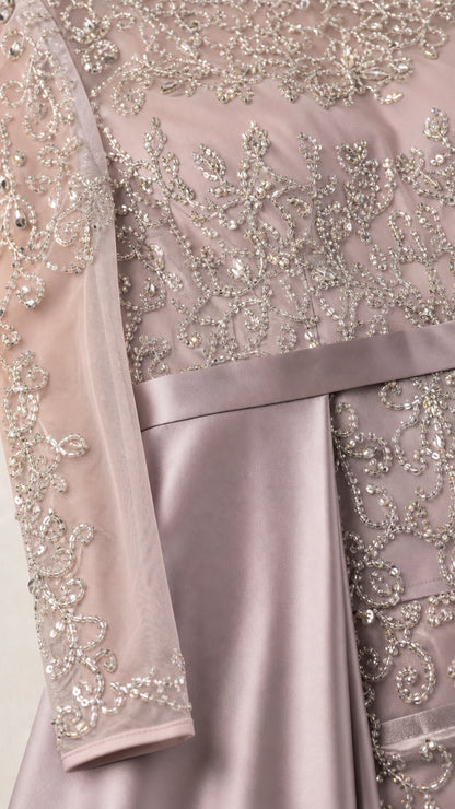 Close-up detail of silver beading, floral embroidery, and smooth satin waistband on gown